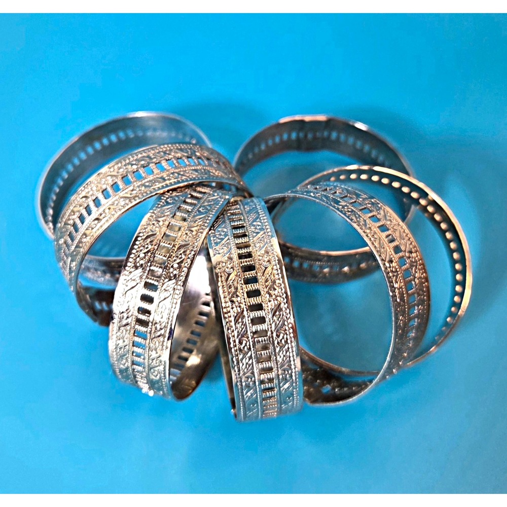 Set of 7 Silver Tone Embossed Metal Floral Napkin Ring Holders